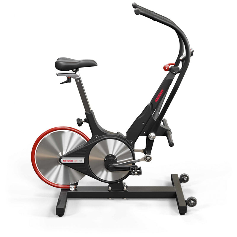 Keiser M3i Total Body Trainer elliptical exercise bike in black with a red rim from the right side on a white background