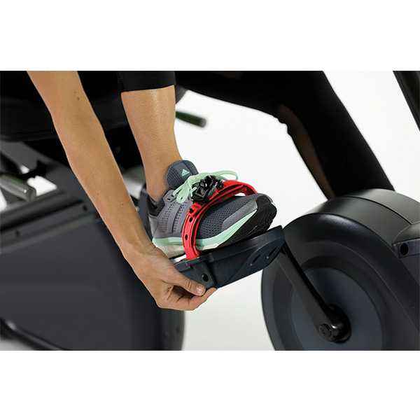 Person tighten the red foot pedal of the Gym Gear R98e Recumbent exercise Bike