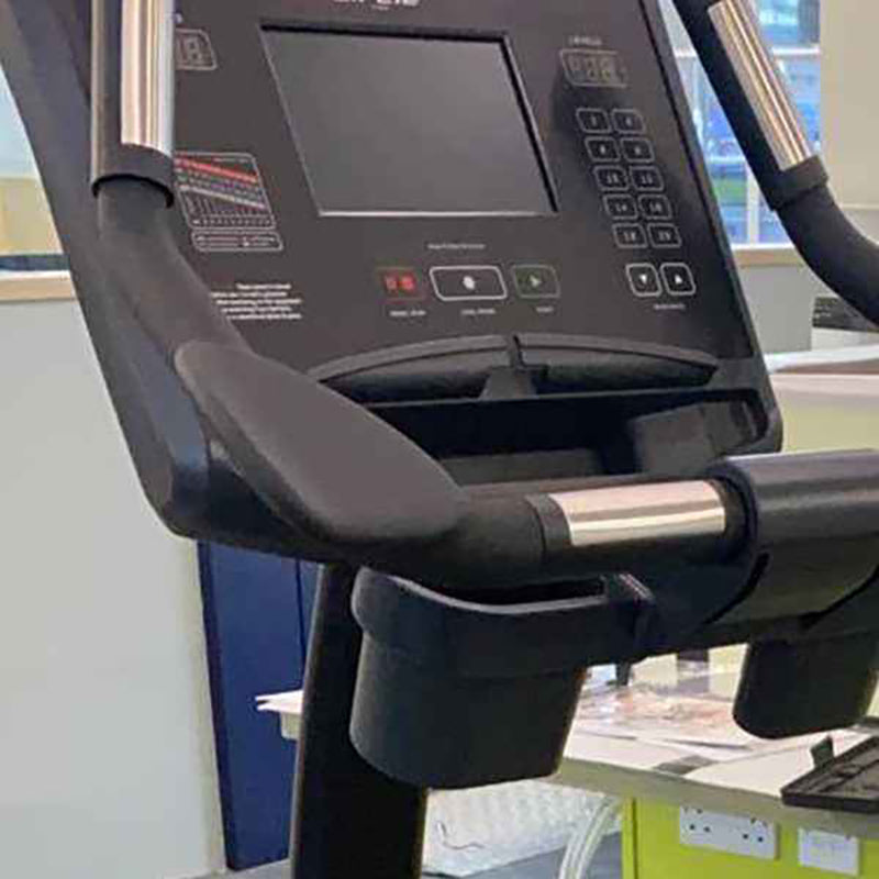 Close-up of a Gym gear C98s Upright exercise Bike handle and control panel in an indoor setting