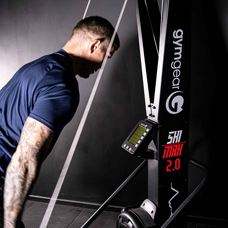 Man using a gym machine with 'gymgear' branding