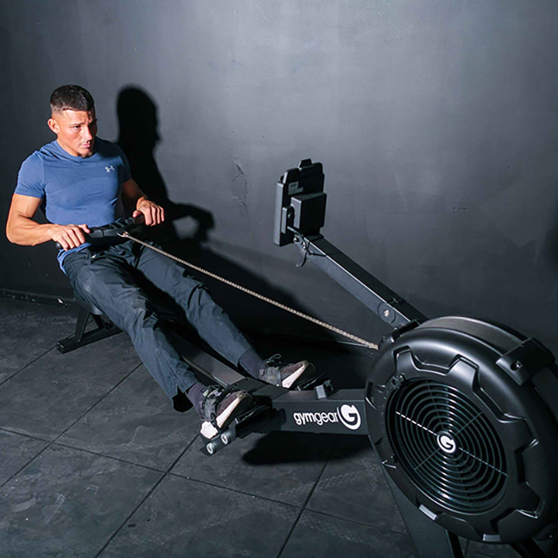 Man using the Gym gear Row Max 2.0 rowing machine in a dark room