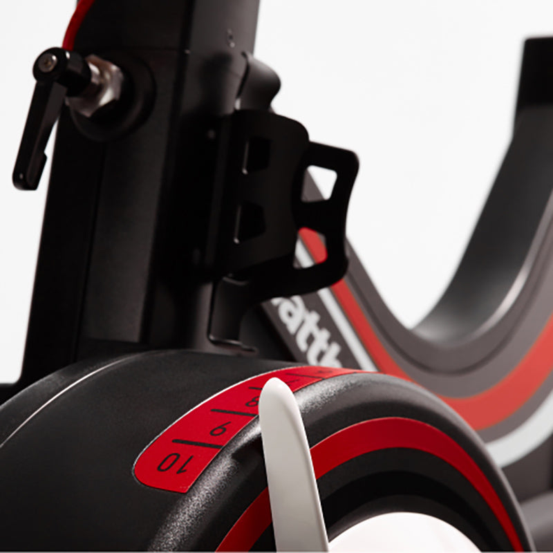 Close-up of the adjustable bike tension on the Wattbike pro trainer in red and black on a white background