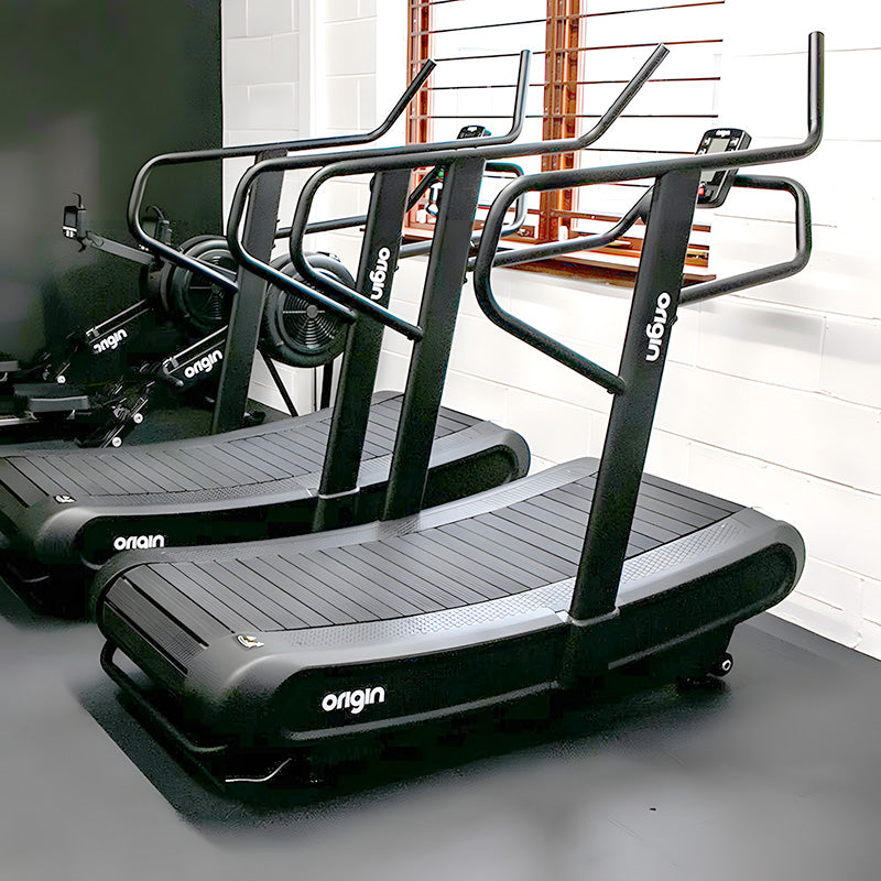 Origin Storm Curved Treadmill Black treadmill with 'Origin' branding, Full view of the product in a gym studio