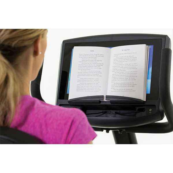 Person using the book stand to read an open book on the Gym Gear R98e Recumbent exercise Bike on a white background