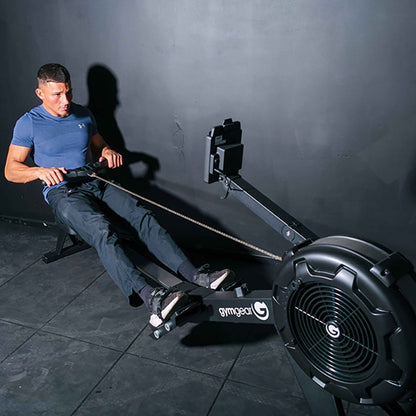 Man using the Gym gear Row Max 2.0 rowing machine in a dark room