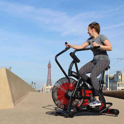 Woman exercising on the Gym Gear Tornado Airbike exercise bike with Blackpool Tower in the background
