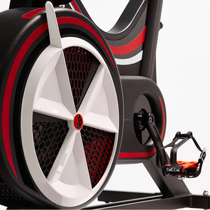 Close-up of a Wattbike pro trainer wheel and foot pedal with red and black design on a white background