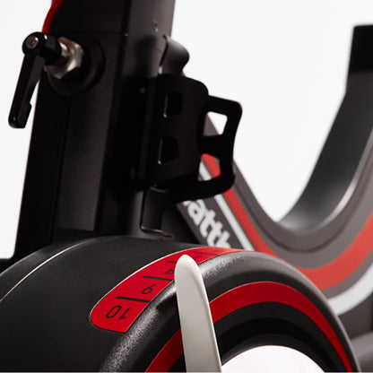 Close-up of the adjustable bike tension on the Wattbike pro trainer in red and black on a white background