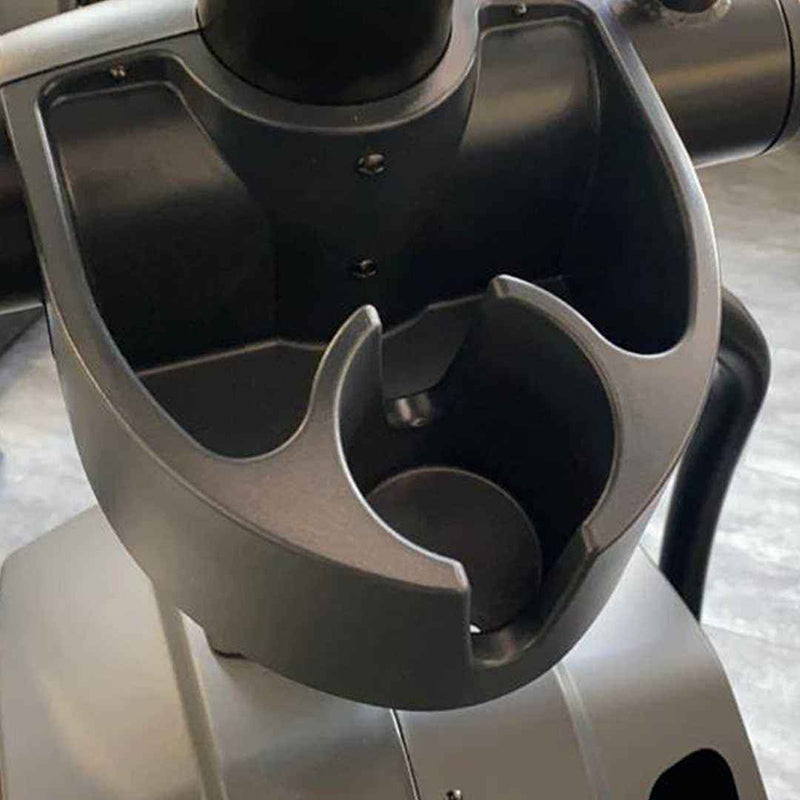 Close-up of a black cup holder attached to a Gym Gear X98s Cross Trainer console.